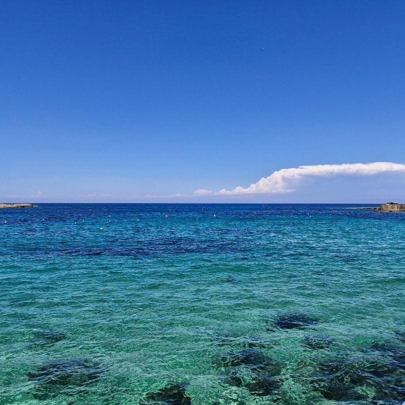 Crystal blue waters against a clear blue sky.