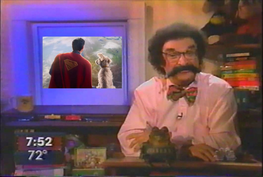 'Today' show film critic Gene Shalit sitting at his desk with a still of Superman and Krypto behind him.