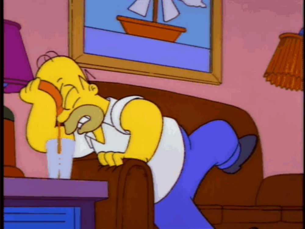 a cartoon of homer simpson laying on a couch talking on a phone