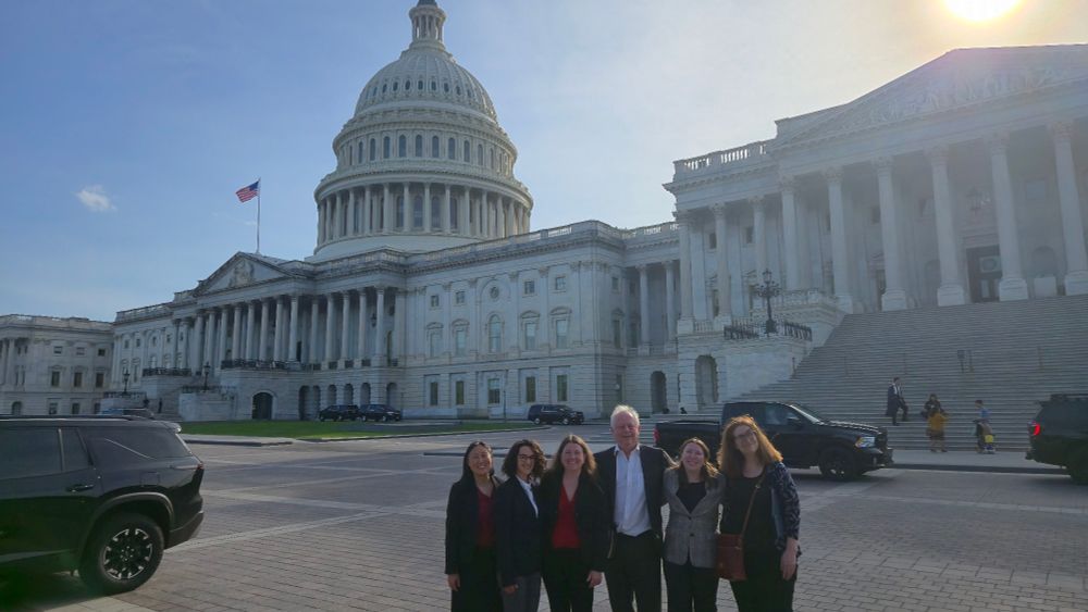 A group of people in front of the US Capitol