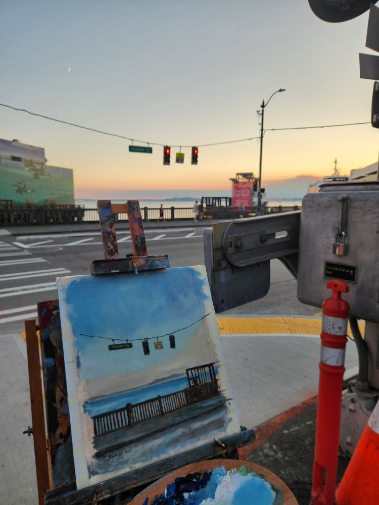 Plein air oil painting of the intersection of Vine Street and Alaskan Way in Seattle Washington, view looking out over Elliot Bay past the Edgewater Hotel on the evening of July 29, 2025