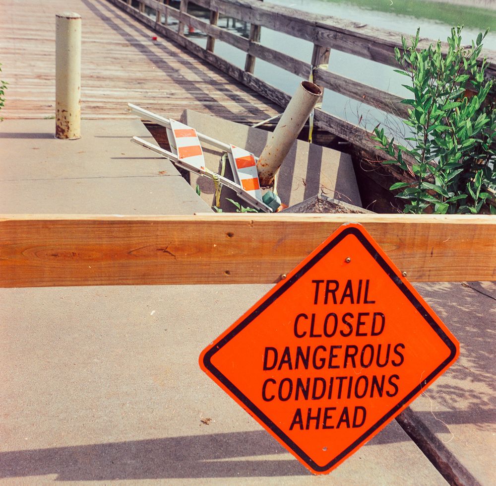 The concrete pier has collapsed in one spot; the slab is lying at an angle and the safety barricade has fallen on its side into the hole.  A good metaphor for 2025?