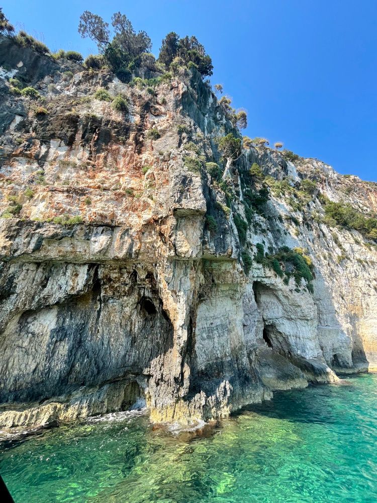 Blue water and layered rock shoreline 