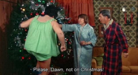 Dawn Davenport stomping on Christmas presents under the tree while her parents look aghast in Female Trouble. The caption reads “Please Dawn not in Christmas!”