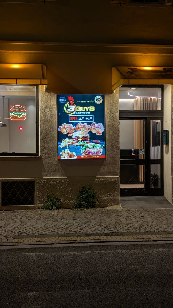 a fast food restaurant called "3 guys" with a chicken as its logo