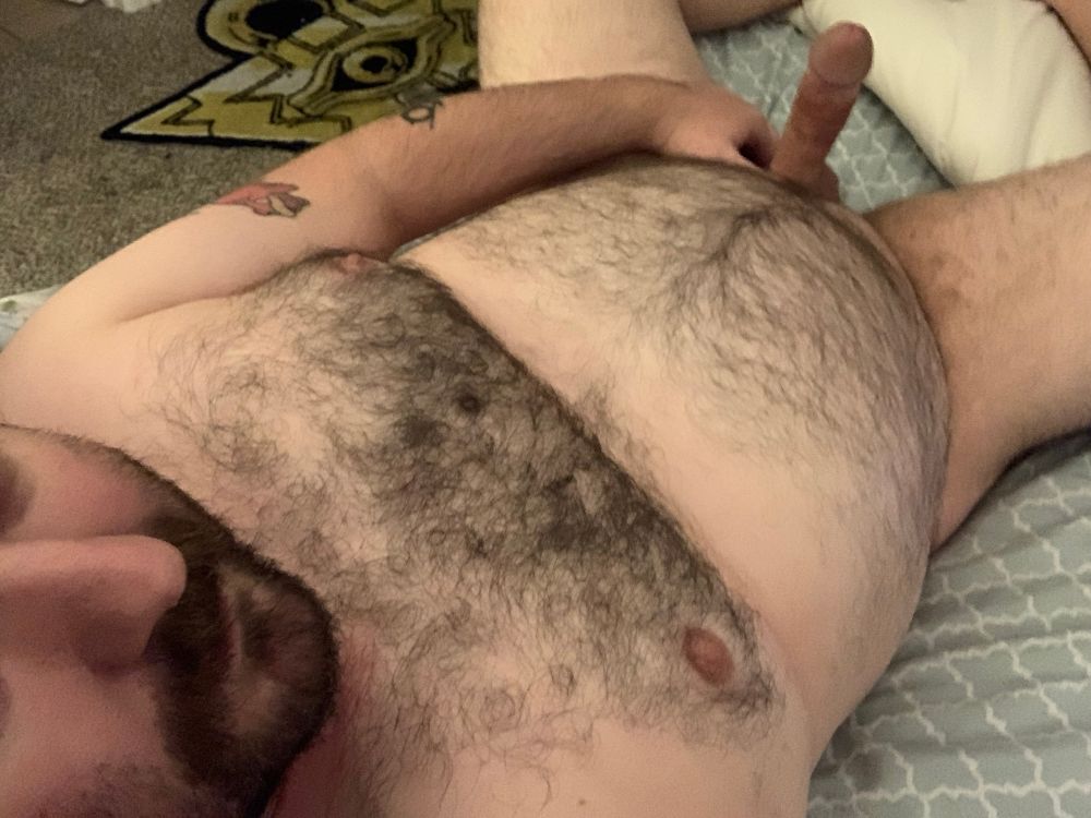 Angled down selfie of me laying naked in my bed, holding up my hard cock