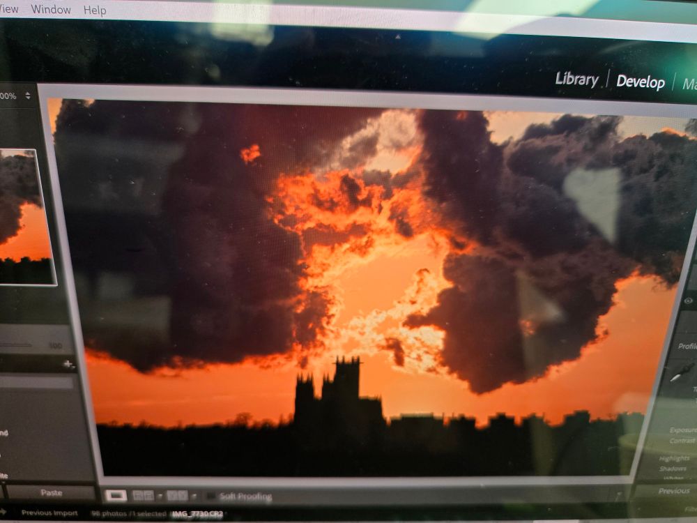 A gorgeous orange sunset with a cathedral blacked out in the background on my omen laptop screen