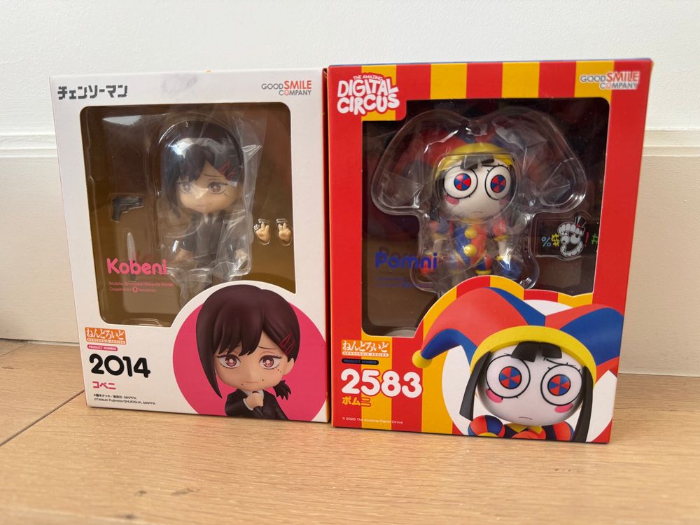 Nendoroid figurines of Kobeni from Chainsaw Man and Pomni from The Amazing Digital Circus in their respective boxes