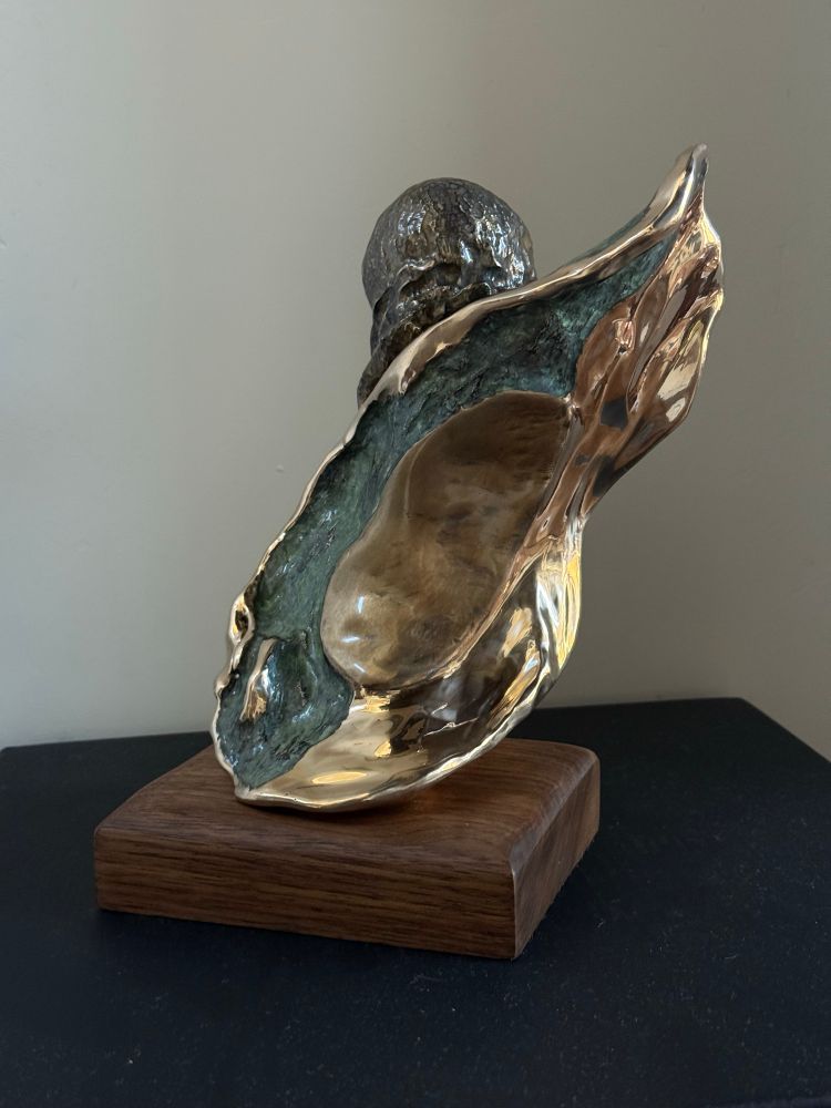Bronze sculpture of a T-cell attacking a cancer cell. 