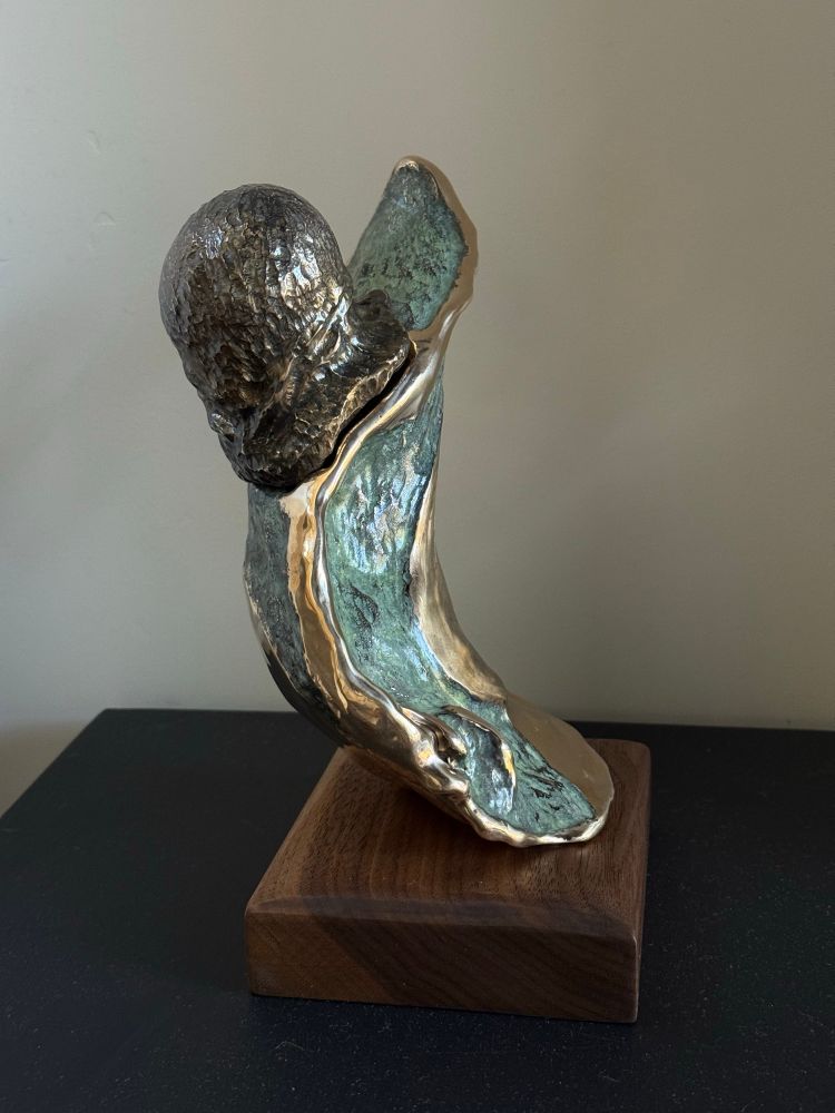 Bronze sculpture of a T-cell attacking a cancer cell. 