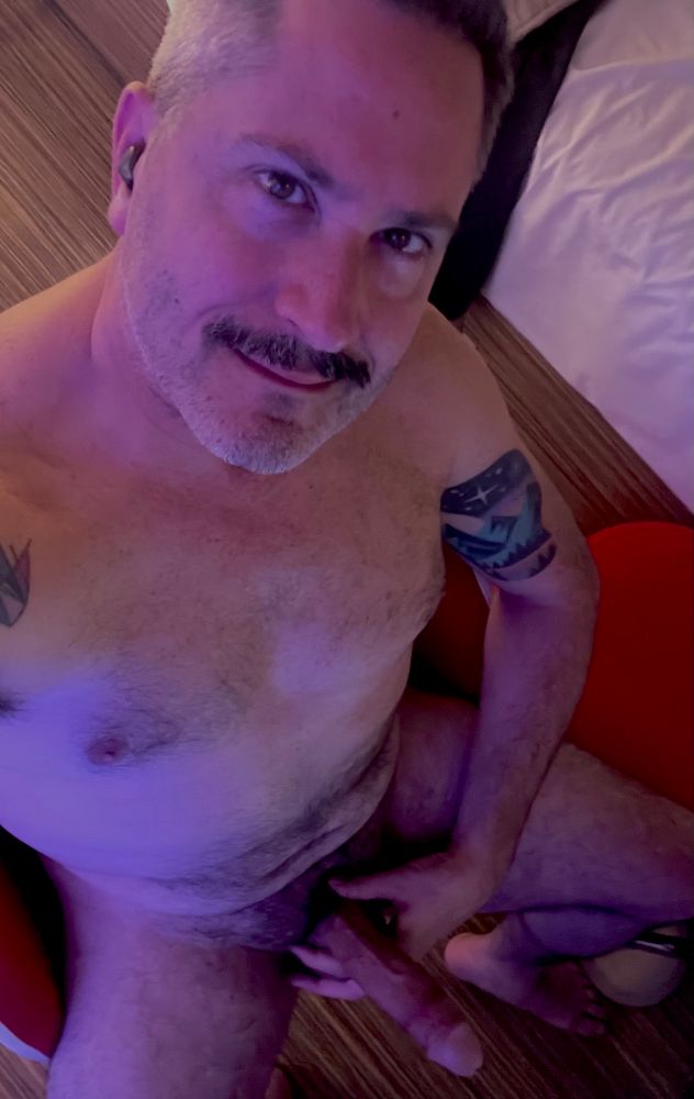 Overhead shot of bator sitting naked and erect, about ready to add to the jizz stains in this hotel room 💦