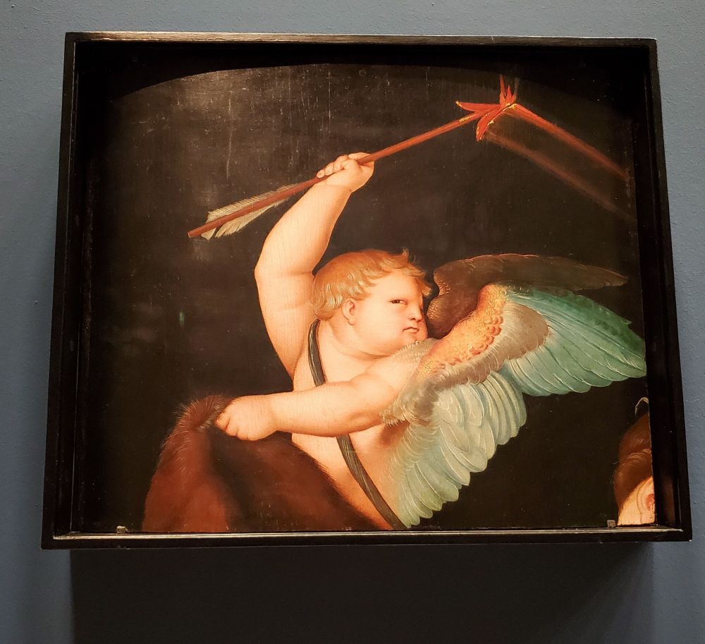 A Baroque painting of a cherub, waving a wand and giving side-eye.
