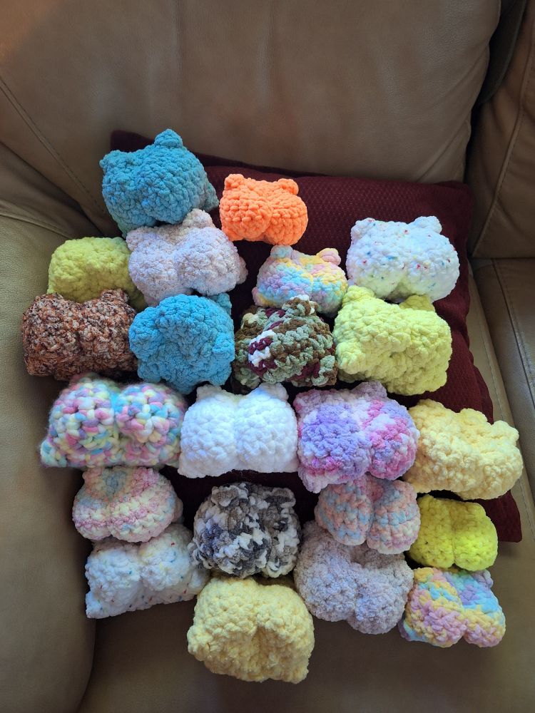 Butts of multi colored frogs 