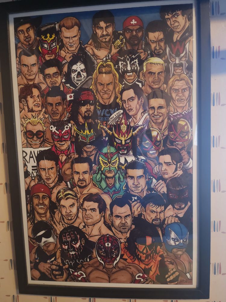 A picture of a framed artwork showing many different Luchadors that wrestled in WCW