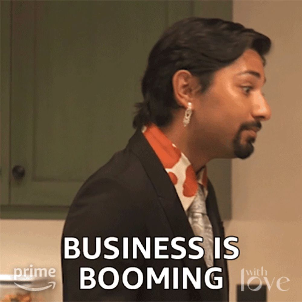 a man in a suit and tie with the words business is booming