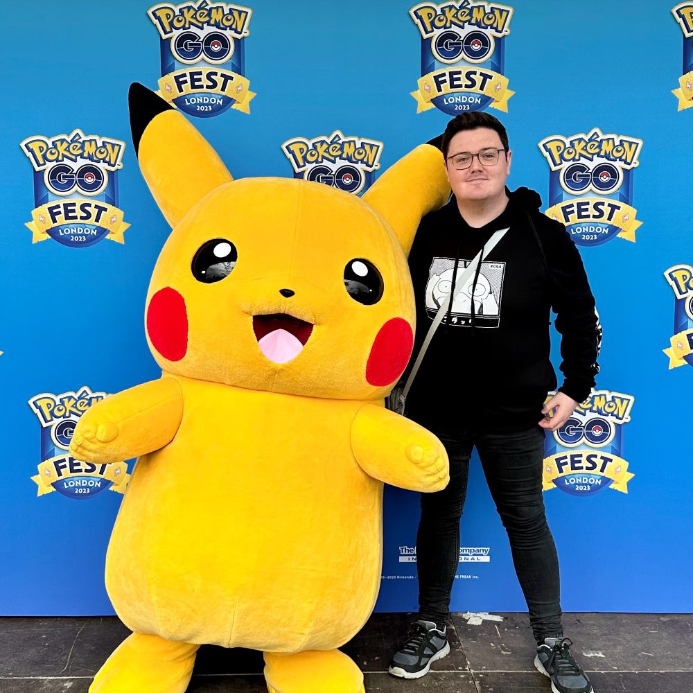 Posing with a Pikachu mascot at Pokémon GO Fest in London in 2023. 