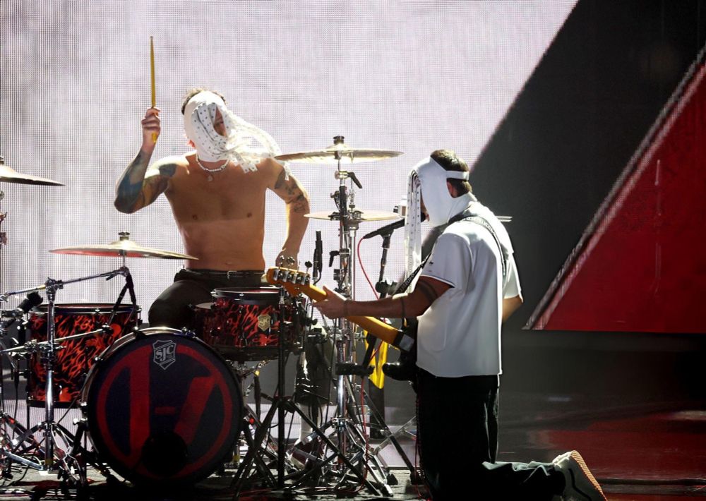 Tyler singing on a microphone that's perfectly put in position for him to be able to play and sing while kneeling at Josh's feet while he plays the drums. I can't with them anymore.