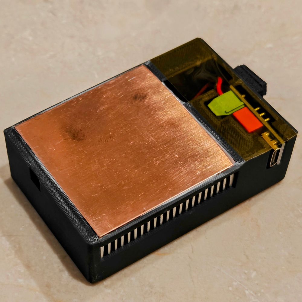 Underside with a copper plate over an aluminium heatsink and a USB-PD decoy trigger set to 12V, covered with Kapton tape.