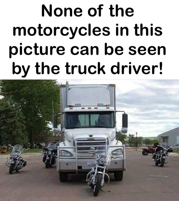 A photograph of a large American Truck with five motorcycles parked in the driver's blind spots. None of the five are visible to the driver. 