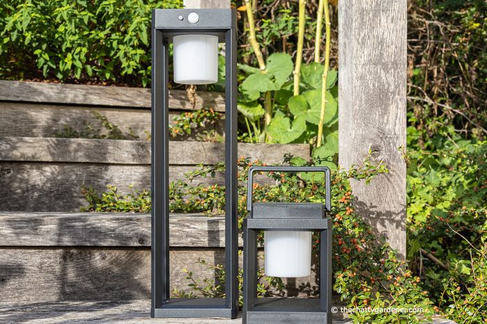 Tall and small garden lanterns sat on wooden steps.