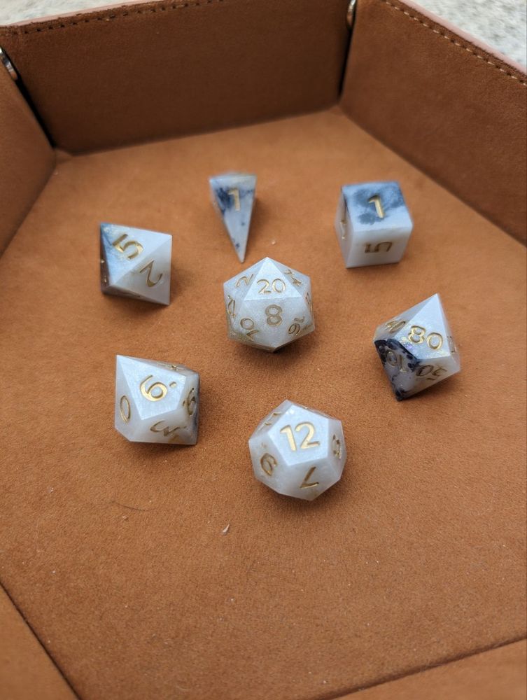 Marbled dice with gold numbers