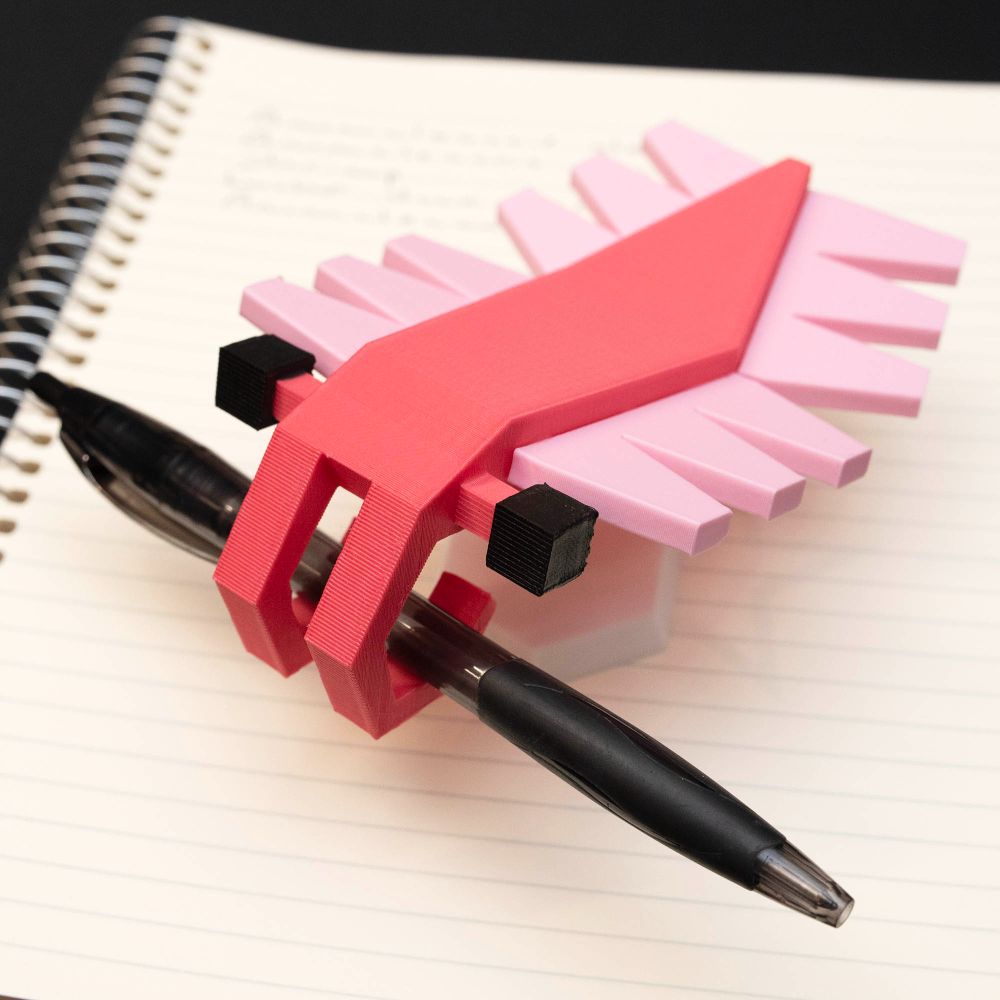 Low poly 3D printed figure of an Anomalocaris. The figure is holding a pen.