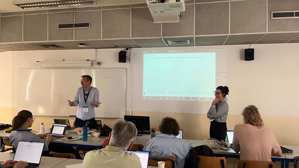 Sean Takats & Anita Lucchesi leading the Tropy workshop with screen projection on the wall behind them.