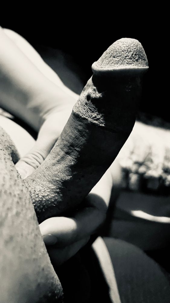 My erect cut cock in black and white. Its tip shining elegantly in the light