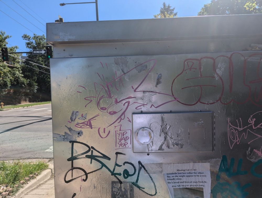Drawing of a coyote saying "yip yap yop" on the side of a utility box.