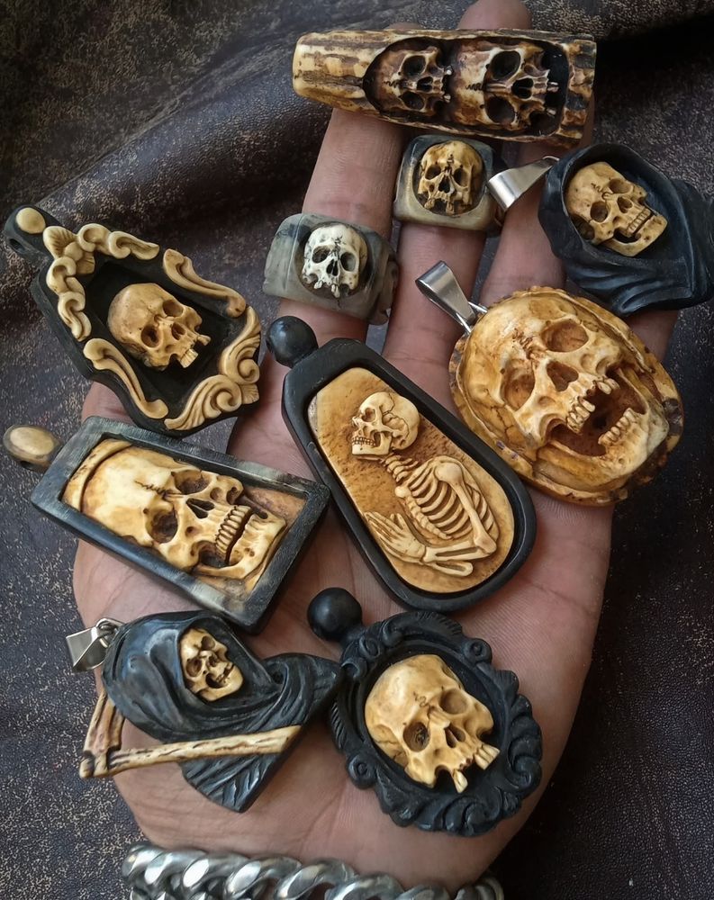 Skull pendants and rings made of carved deer antler and buffalo horn