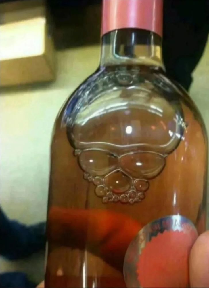 Wine bottle with bubbles in the shape of a skull