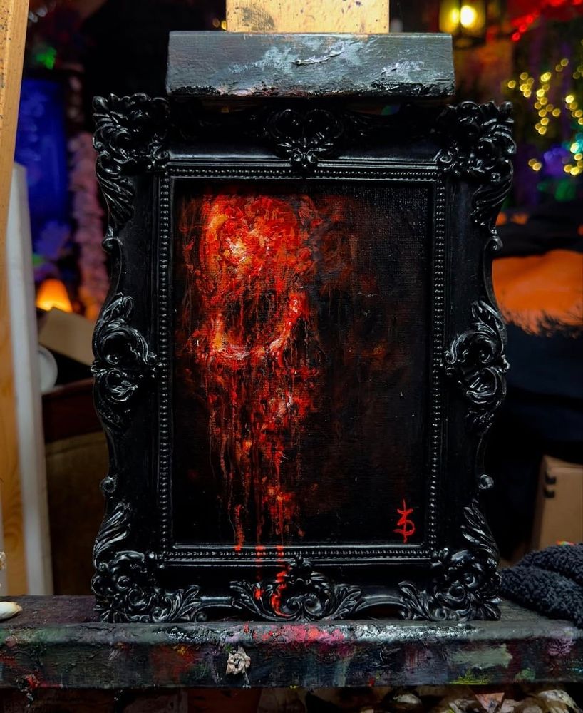 Red skull with blood dripping down over the bottom picture frame