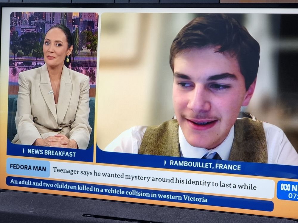 Photograph of television showing split screen on news program of host interviewing guest. 