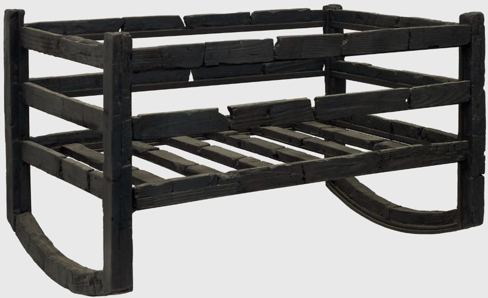 Black and white image of a carbonized wooden cradle for an infant.  It as a slatted bottom and curved runners that would have allowed it to be rocked. 