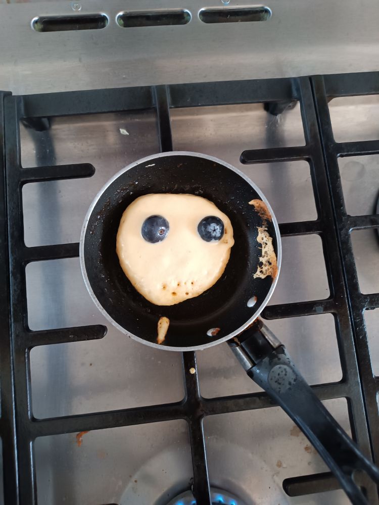 A small pancake (American style, not British pancake) with only two blueberries as eyes and a wry smile made from bubbles. That's how I feel. 