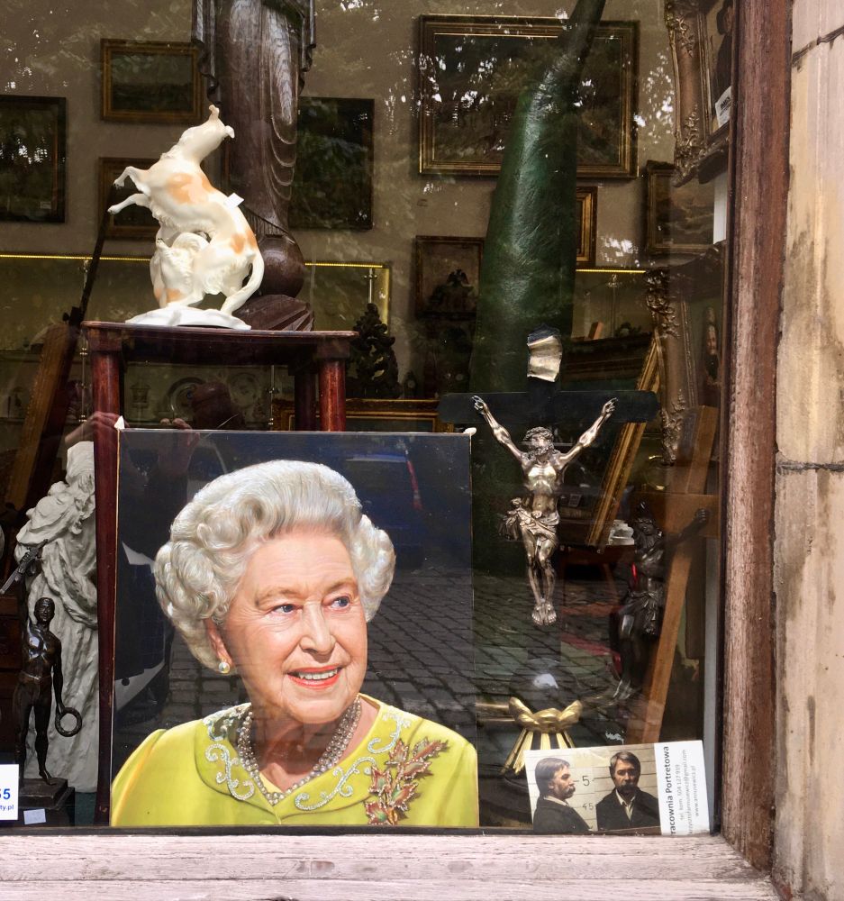 The Queen, Jesus and… mugshot of an unknown moustachioed man in an antique shop window