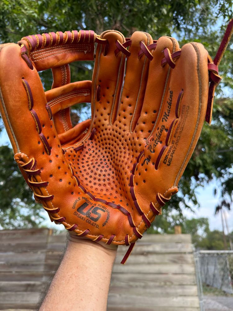 A wild and unique U&S Sasaki (now SSK) USG-50 model glove I restored. It is labeled The Catching Machine along the pinky and features a dimple pattern in the palm. The theory was that this would help grip the baseball better on fielding, similar to the texture of a basketball’s surface. This is a large outfielder’s model, probably 12.5 inches.