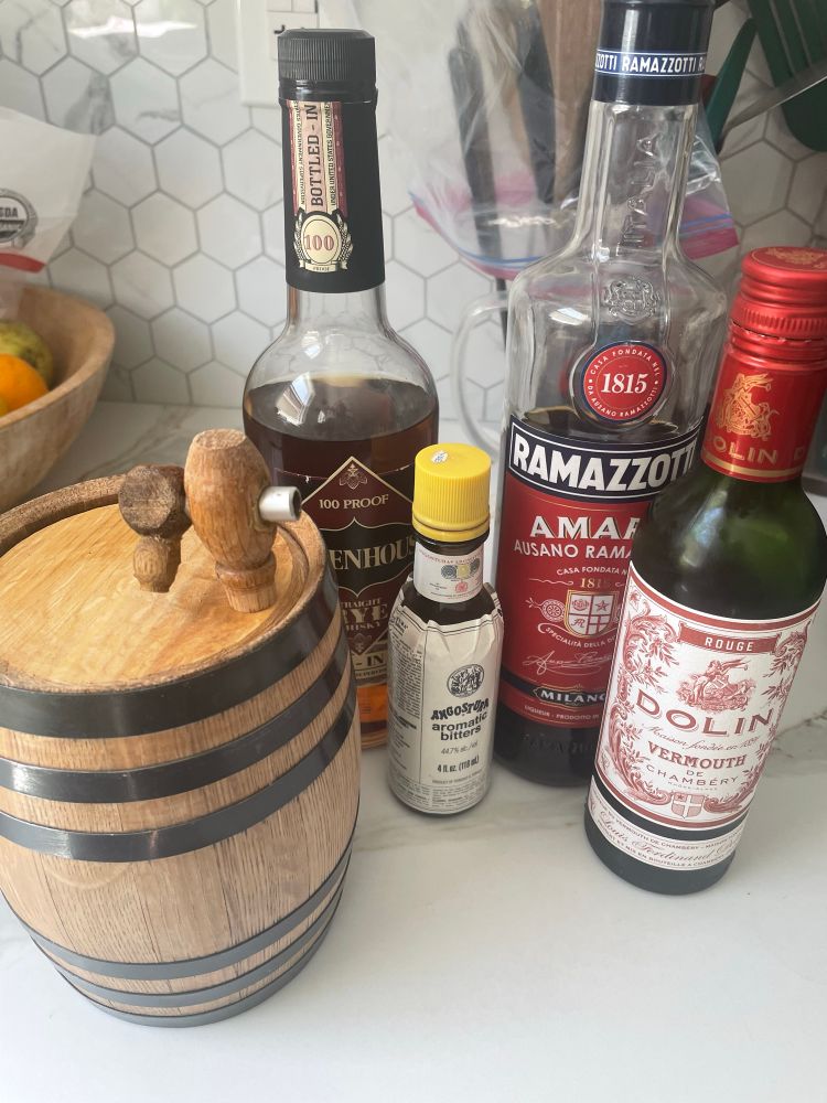 Photo of lined up ingredients for Black Manhattan that’s going in the barrel.