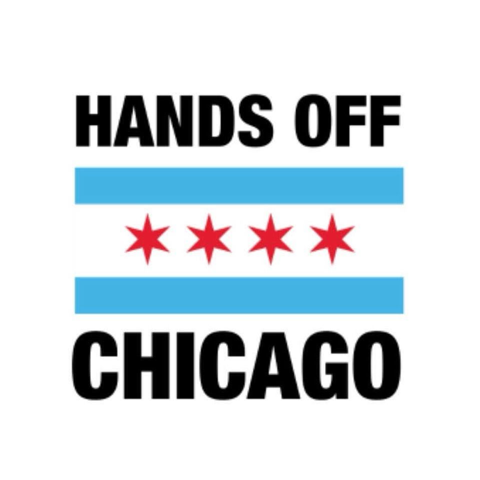 Sign says “Hands off Chicago” with a graphic from Chicago flag: 2 blue lines over and under 4 red stars