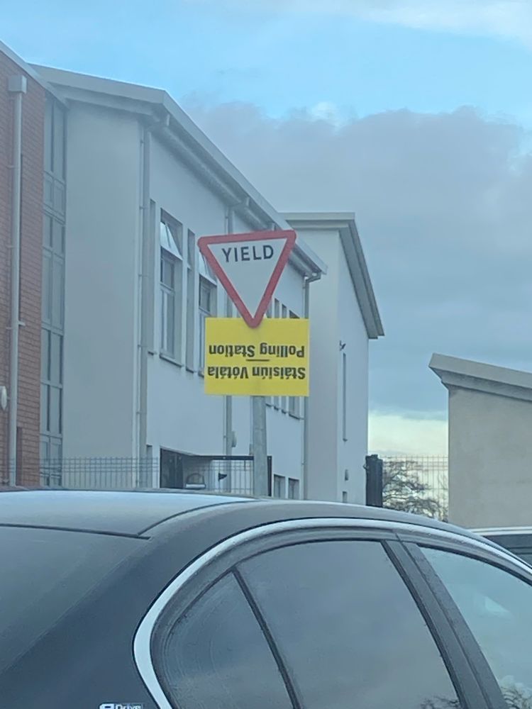 A picture of a sign indicating a polling station ahead of the Irish General Election. The sign is yellow and reads “Stáisiún Vótáil - Polling Station”
The sign was placed upside down. 