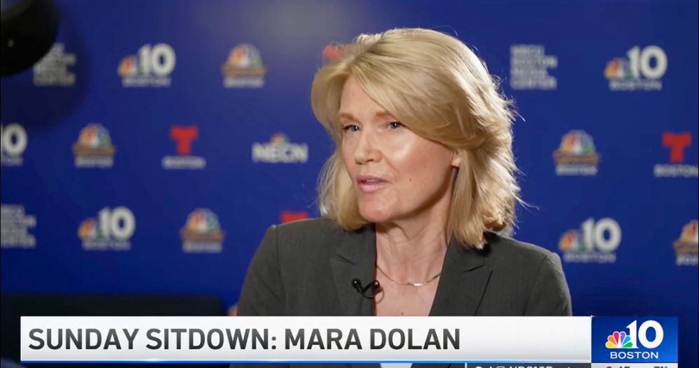 Mara Dolan in grey suit and white shirt at NBC Boston studio. 