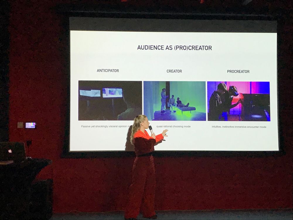 Victorine van Alphen explaining the roles involved in her art installation IVFX. As artist she anticipated what people would do, she was the creator of the art installation, but the visitors of her installation are the procreators as they create the virtual babies.