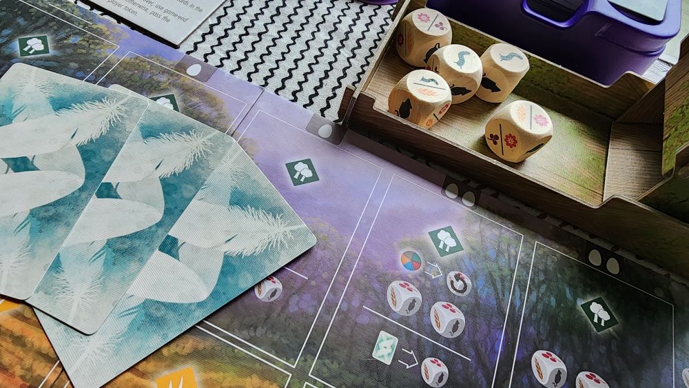 The photo shows the new player board and food dice for the Oceania expansion to Wingspan. 