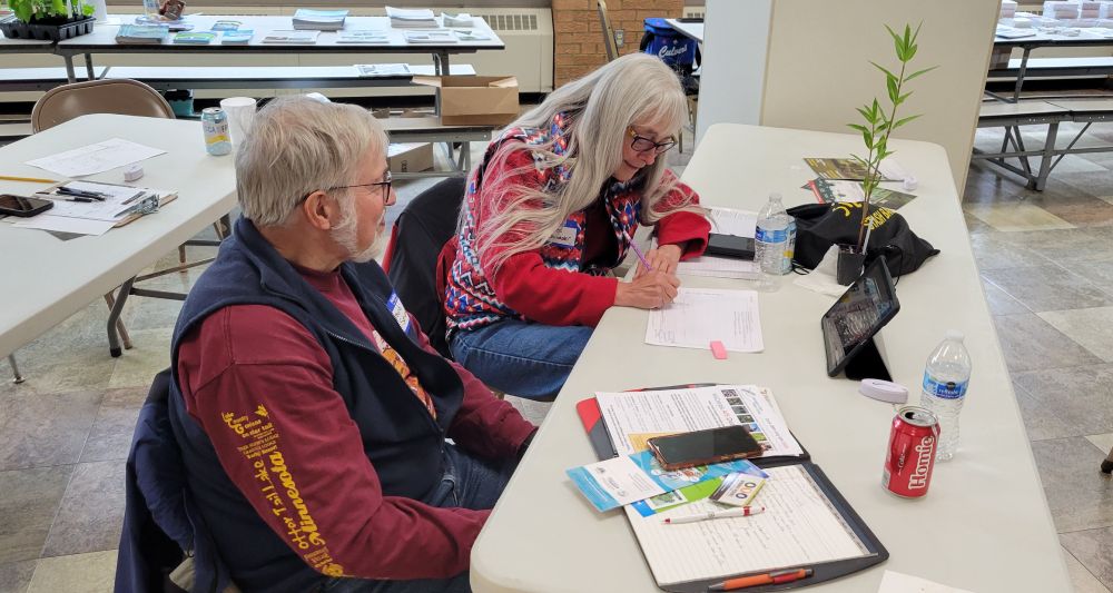 Homeowners sketch out their wants and ideas for their inland lake shoreline homesite, including plans for planting the native plant they received as a thank-you for their participation. 