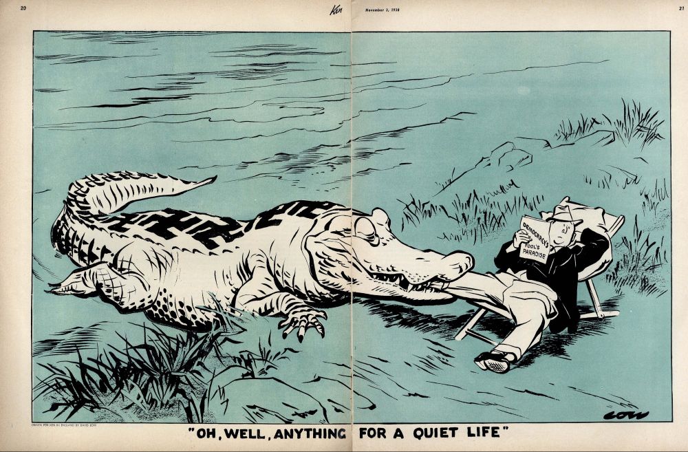Cartoon of a large alligator with swastikas on its back coming out of water on to shore.  A man is sitting in an easy chair on the shore. He holds a paper labeled "Democracy's Fools Paradise".  He looks generally unconcerned as the alligator has one of his legs in its mouth to above the knee.  Caption: "Oh, well. Anything for a quiet life."