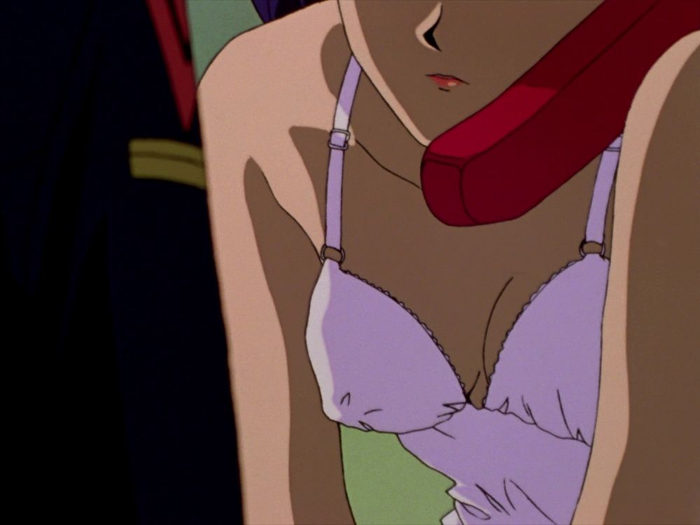Misato talking on the phone in a cold room