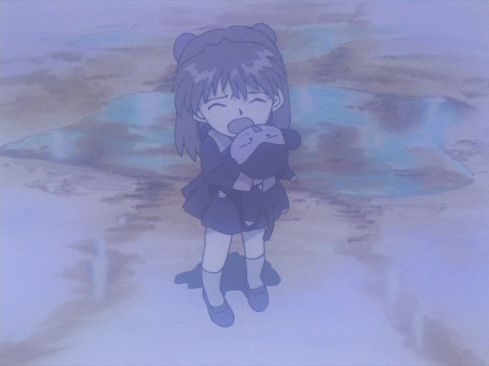 Little Asuka crying while holding a stuffed monkey