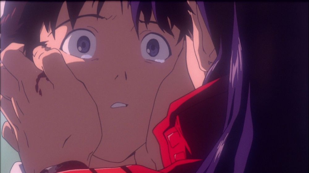 Misato holding Shinji's face