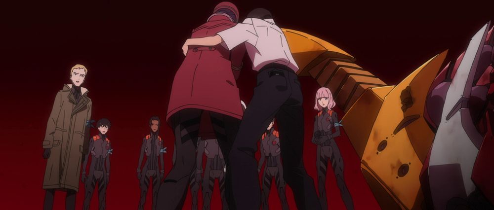 Shinji helping Misato walk in front of Ritsuko, Maya, and other WILLE personnel