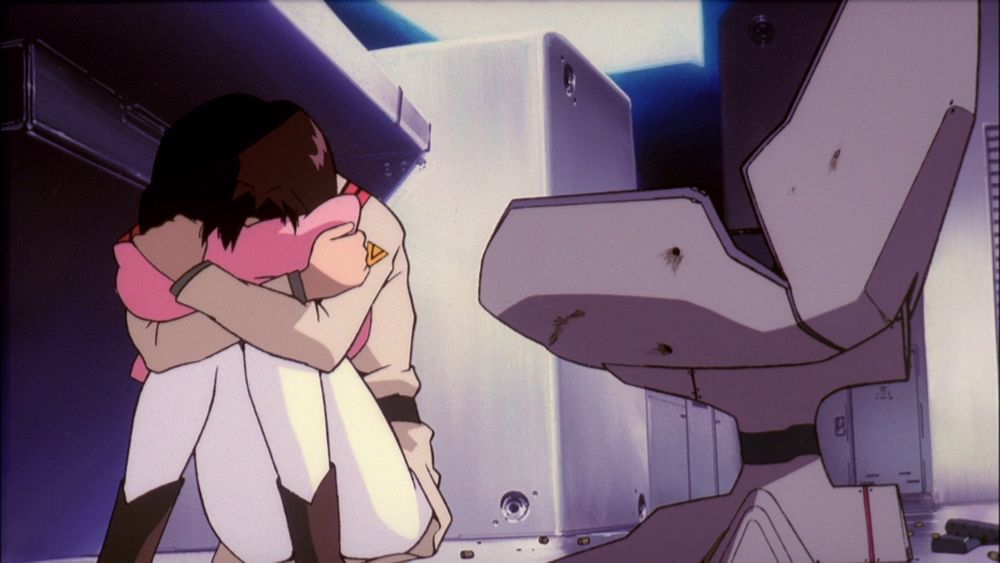 Maya hugging her pillow under the console